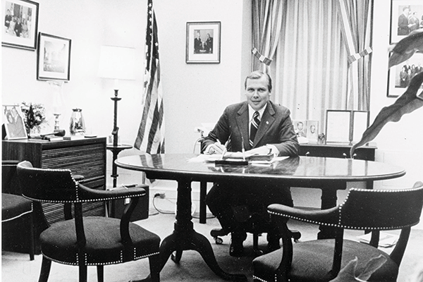 young Jon Huntsman sitting at a white house desk