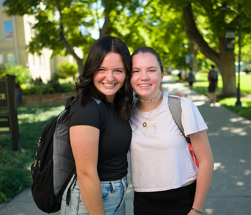 two girls walking on campus